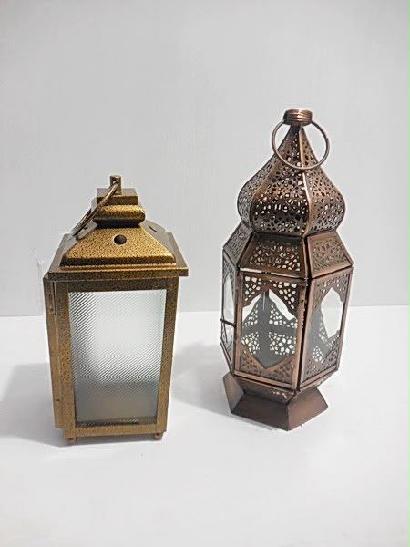 Two metal and glass lanterns in different finishes